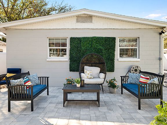 Outdoor Pergola with lots of seating, dining, and outdoor TV for entertainment