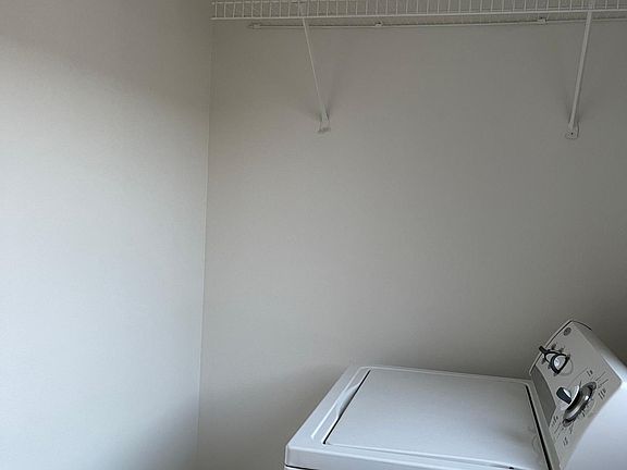 Laundry room with storage racks