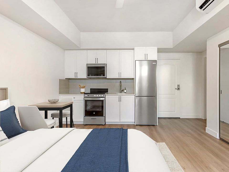 Renovated Package II kitchen, living, and dining area with hard surface flooring