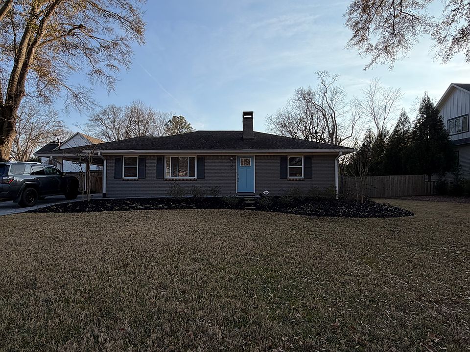 Front exterior of single-level home with landscaped front yard and driveway