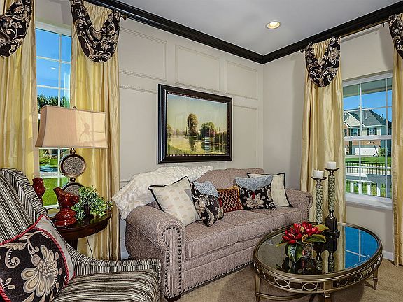 The formal living room, which adjoins the formal dining room, offers an ideal layout for entertainin