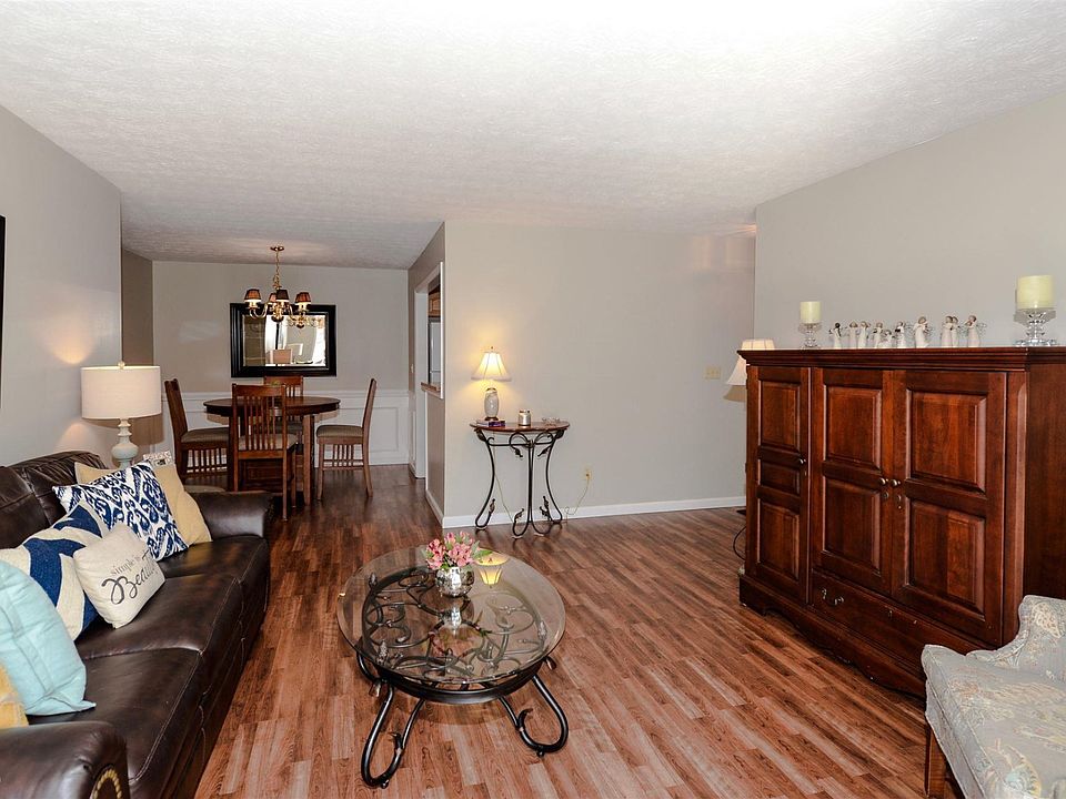 Welcoming living space is open to dining area and sunroom.