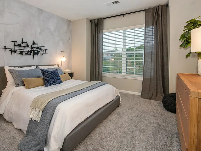 Discover lavish guest bedrooms with plush carpeting and ample space for serene living.