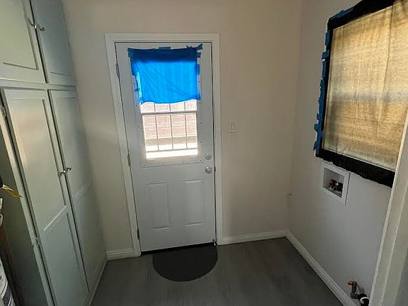 washer/dryer area and closet off of the kitchen. Door to backyard.