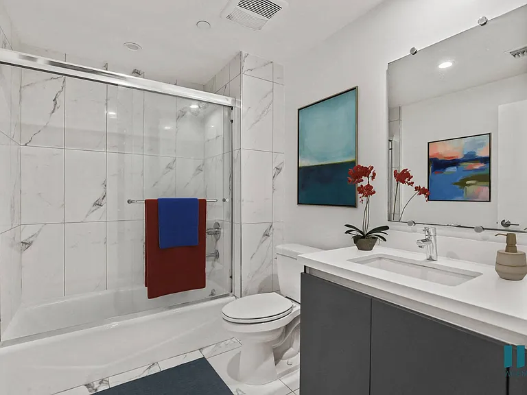 Bathroom with Shower Bath with Glass Door and Vanity Cabinet Storage