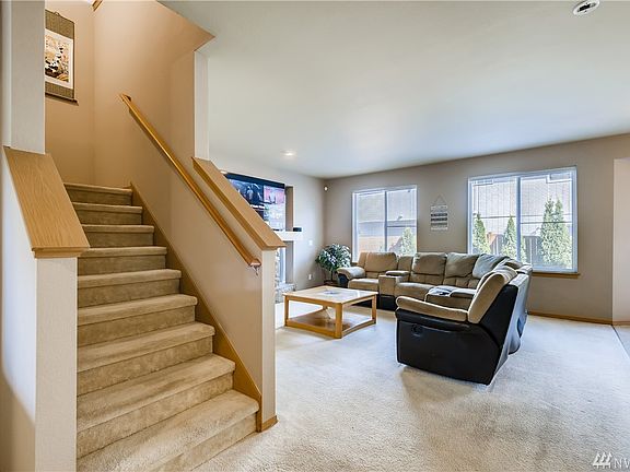 Steps away from the formal dining room is the staircase leading upstairs and the open family room next to it.