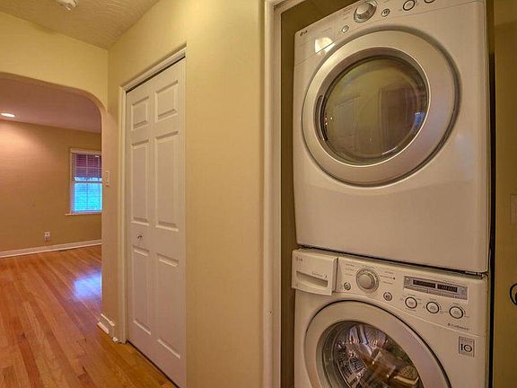 stacked laundry near bedrooms and bath