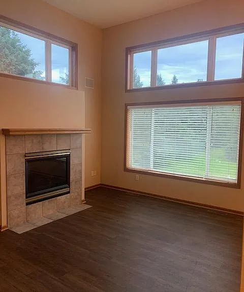 Lovely end unit living room with great sunlight, gas fireplace and newer LVP flooring.