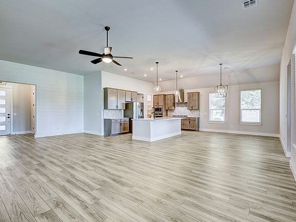 Open-concept layout with the spacious family room leading to the dining area and kitchen.