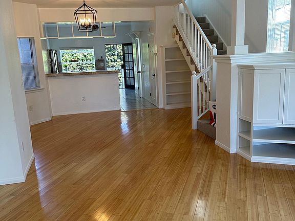 Open floor plan view of living, dining room and kitchen as you enter