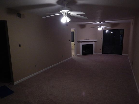 Big Family Room with fireplace, sliding glass doors out to deck and ceiling fans for efficient heating and cooling. Washer and dryer hook ups right around the corner