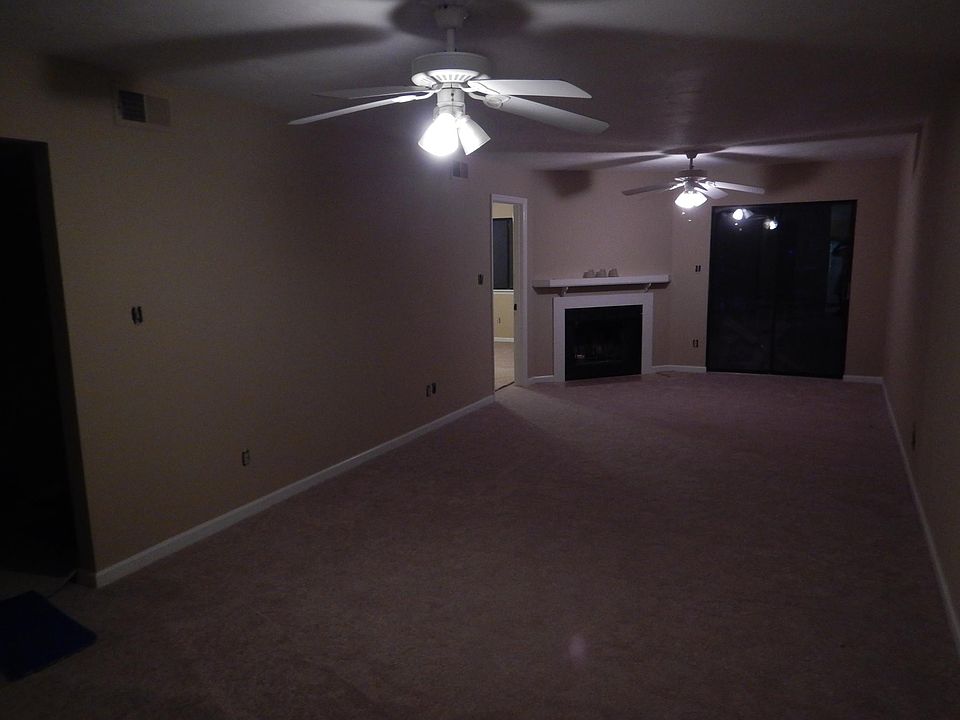 Big Family Room with fireplace, sliding glass doors out to deck and ceiling fans for efficient heating and cooling. Washer and dryer hook ups right around the corner