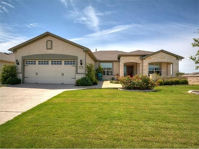 Beautiful Home with professionally landscaped yard and covered patio.