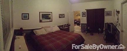 Master Bedroom : Sliding glass door leading to backyard behind the curtain.