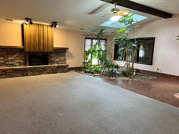 very large family room with sky lights
 fireplace and garden.