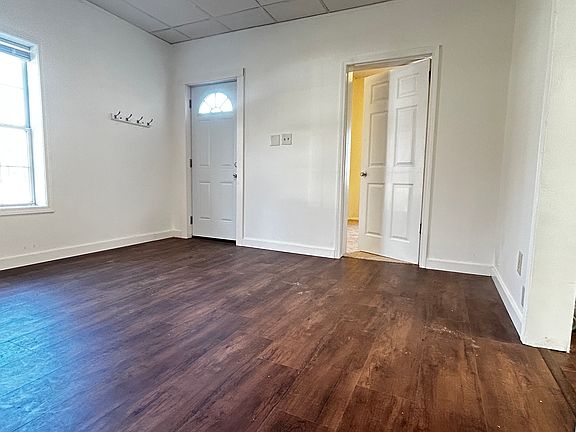 Living room, looking towards the bedroom and the door that leads to the porch.