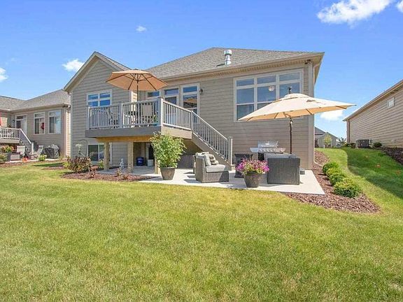 Back of house faces pond, upper patio and lower cemet deck.
