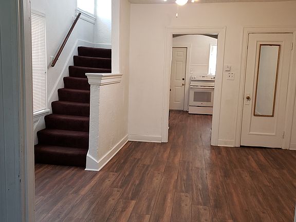 Dining room with ceiling fan, overhead lighting, closet, access to kitchen, backdoor, & access to upstairs & back yard. Ceiling fans in every room except bath.