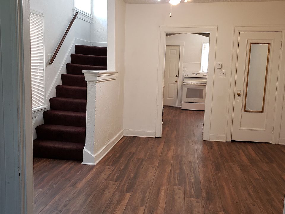 Dining room with ceiling fan, overhead lighting, closet, access to kitchen, backdoor, & access to upstairs & back yard. Ceiling fans in every room except bath.