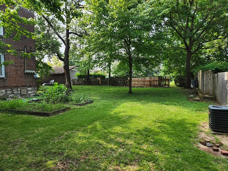Large shared fenced in side yard can be used for grilling, gardening.