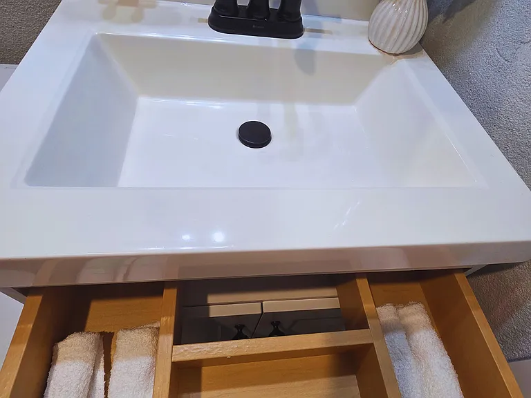Elegant vanity with decorative floral arrangements.