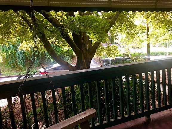 Beautiful old Japanese maples shade the front porch and provide privacy from the street.