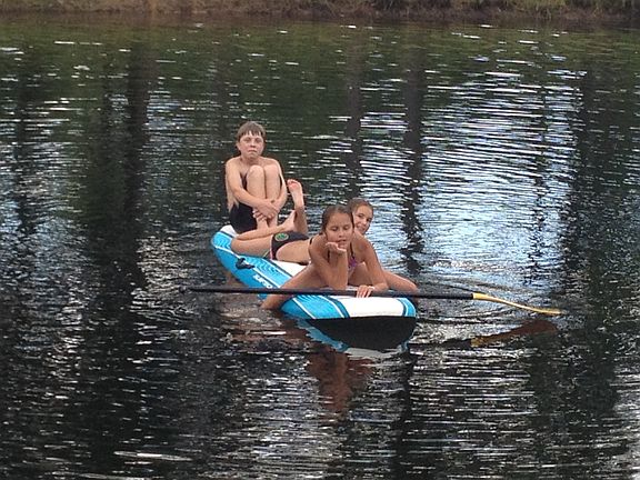 Kids Paddle Boarding in Pond
