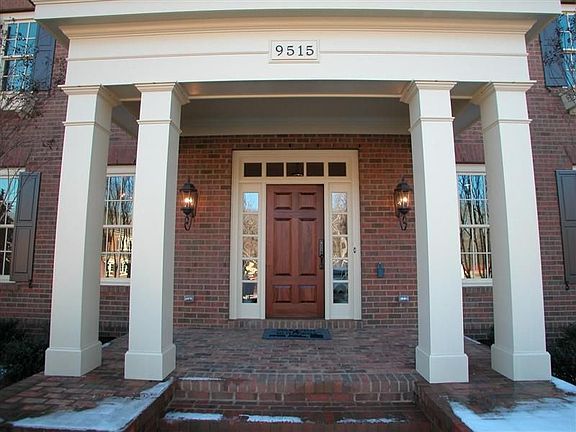 Inviting front entry with porch flanked by columns