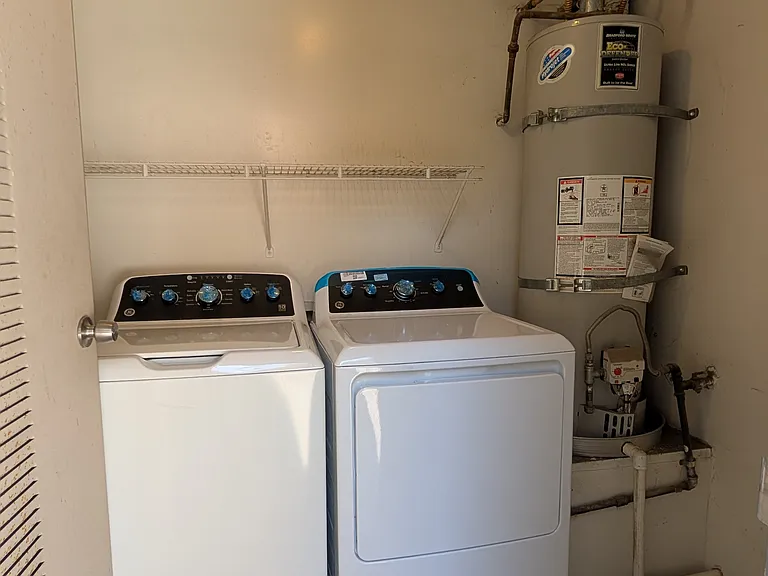 Private laundry room on balcony with new washer and dryer.