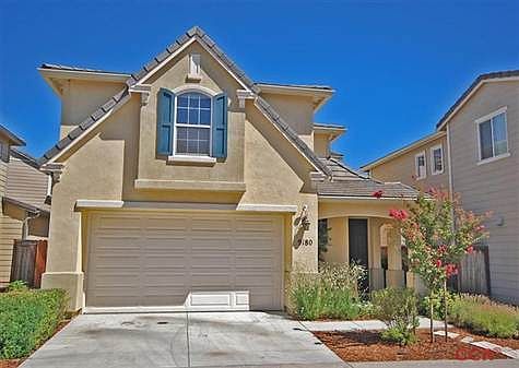 Two car garage with dry-walled interior, shelving and automatic roll up door.