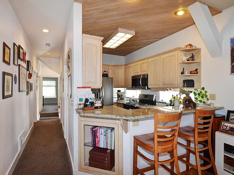 Hall to bedroom 2 and kitchen bar