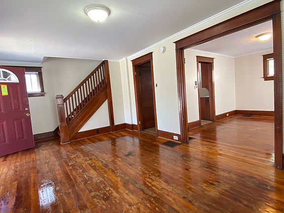 View of the front door, staircase and dining room while in the living room.