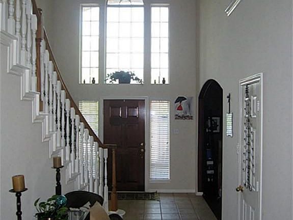 High ceiling throughout the entryway and den.