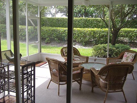 Beautiful back porch with ceiling fan and lighting
