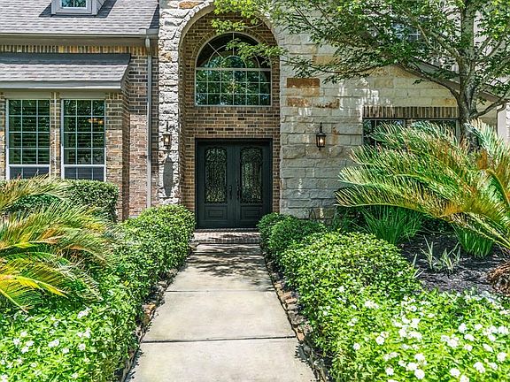 Stunning double wrought iron doors greet you as you approach this beautiful home.
