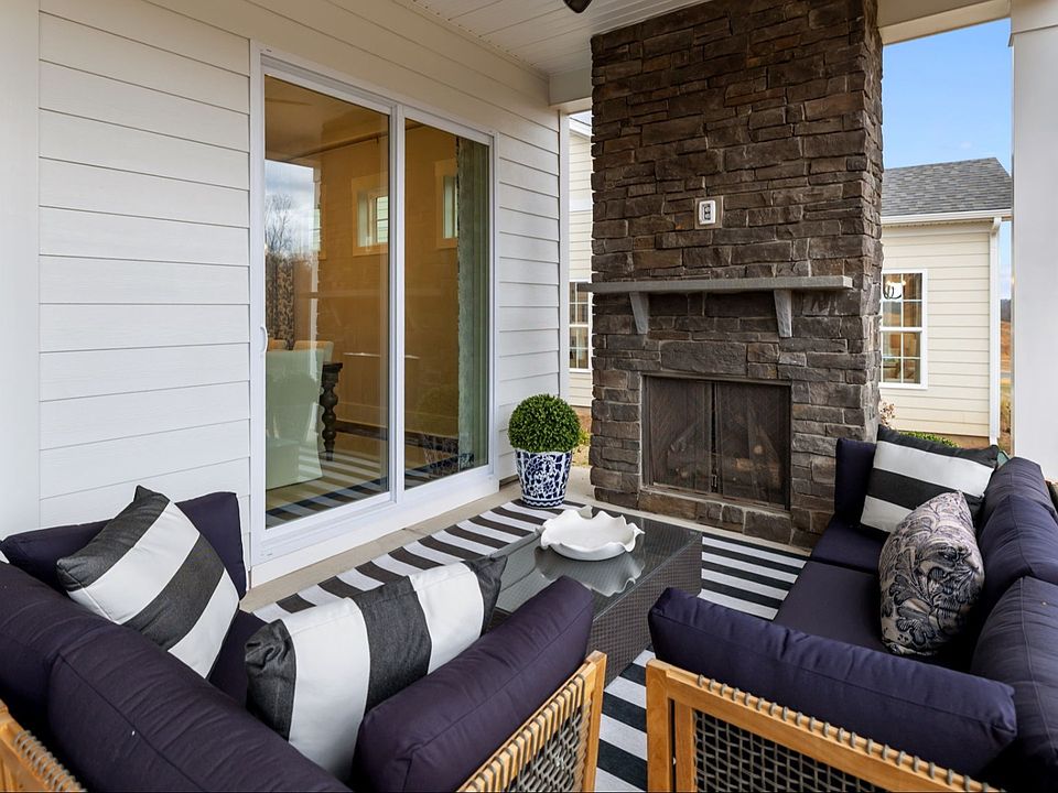 The Adventurer Plan by DBR Homes with a spacious rear porch and stone fireplace in Fort Mill, SC