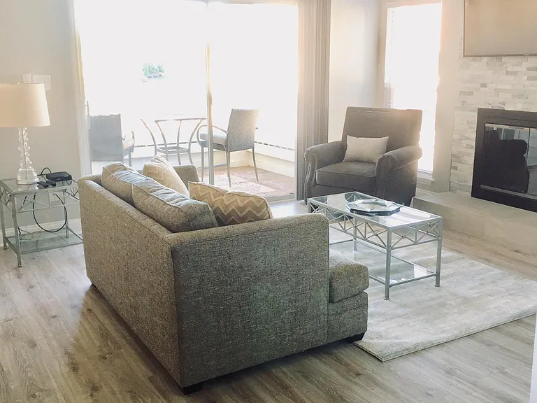 Living room with a view of the lake. Cathedral ceiling only on third floor condo.
