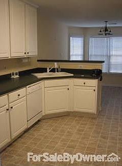 Kitchen with Cabinets Galore
						:
						Cupboards line the Kitchen with Dishwasher, Stove, Microwave, Fridge and Pantry.