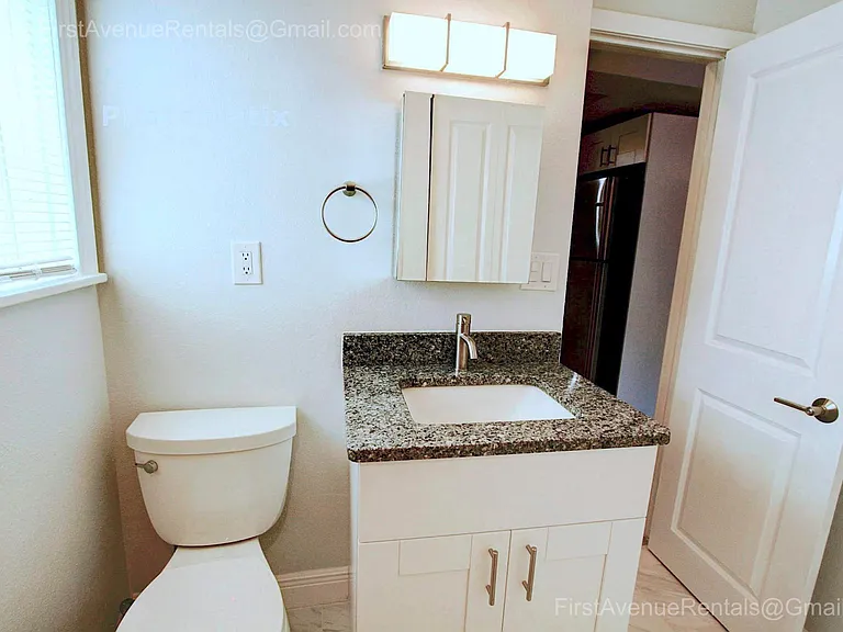 Solid wood vanity with granite top, new commode, fully mirrored medicine cabinet, more bathroom storage to the right in later picture