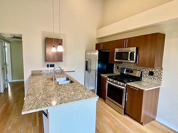 Fully appointed kitchen with granite countertops and stainless steel appliances.