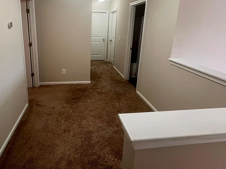The hallway upstairs with separate thermostat.