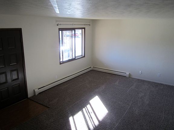 Living room with large window coat closet