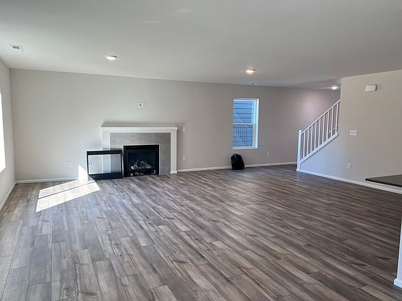 Spacious living room with great natural light, a fireplace, and an open-concept layout.