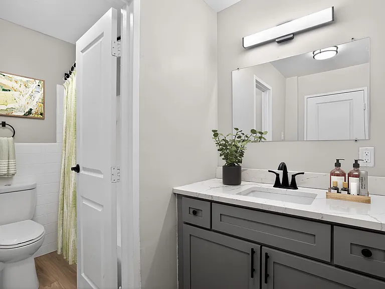 Elevate your living standards at Merrill House Apartments, where modern design meets comfort. This beautifully designed bathroom features elegant fixtures and ample lighting, perfect for your daily routine. Schedule a tour today!