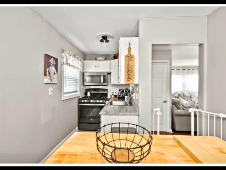 Recently renovated kitchen with updated lighting fixtures, fresh paint,modern cabinets , and generous space for cooking and dining essentials.