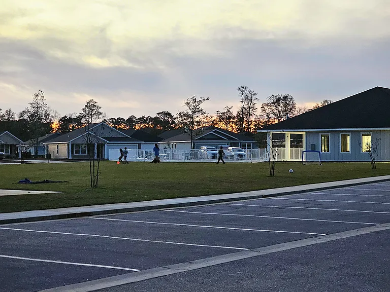 Large green area with pool and clubhouse across the street. Clubhouse has full kitchen, bar, gym, and big screen with free cable.