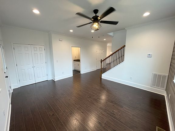 Living room from corner. Front closet & powder room visible.