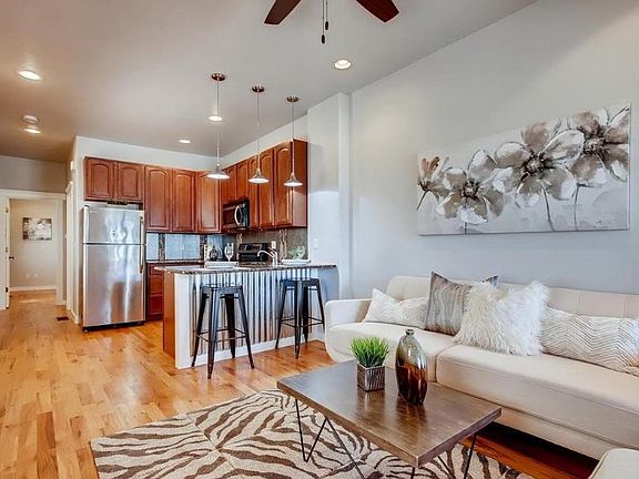 Modern interior with plenty of natural lighting, spacious, open floor plan between living room and kitchen, perfect for entertaining.