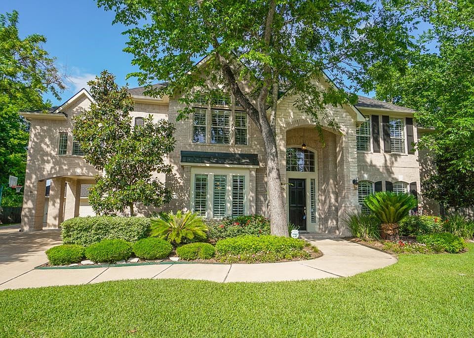 Gorgeous 5 bedroom home in the highly desired Grand Lakes subdivisionNestled amongst mature trees this home sits on a 1/2 acre lot. It backs to bayou and walking trail. Porte cochere and 3 car plus garage. Beautiful curb appeal.