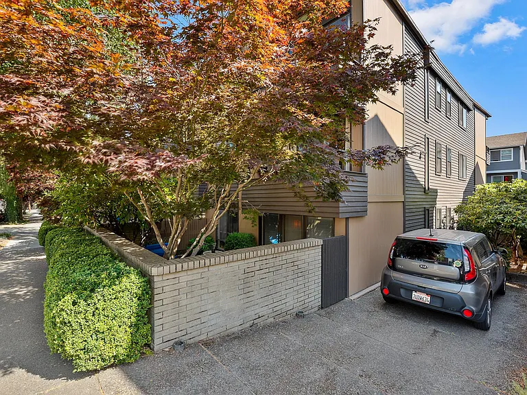 View of apartment and parking space, private patio of unit #103